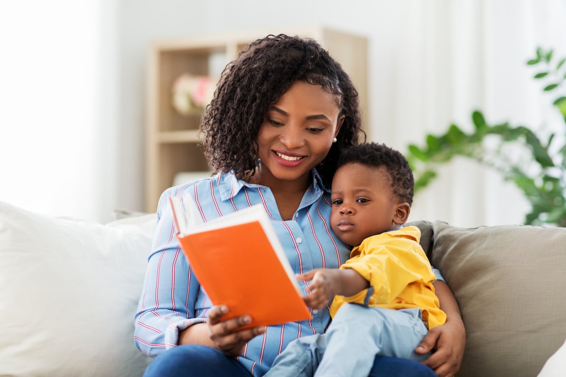 Mother with Book and Baby at Home